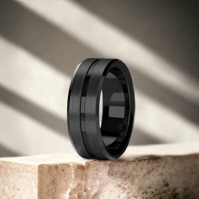 Black titanium ring on a cream marble stone