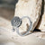 Sterling silver fidget ring on a stone counter top